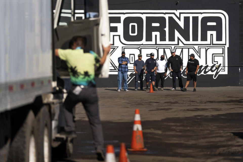 Student drivers wait for their turn to get behind the wheel at California Truck Driving Academy in Inglewood, Calif., Monday, Nov. 15, 2021. Amid a shortage of commercial truck drivers across the U.S., a Southern California truck driving school sees an unprecedented increase in enrollment numbers. The increase is big enough that the school is starting an evening class to meet the demand, according to Tina Singh, owner and academy director of California Truck Driving Academy. "I think that's only going to continue because there's a lot of job opportunities. We have over 100 active jobs on our job board right now," said Singh. The companies that normally would not hire drivers straight out of school are "100 percent" willing to hire them due to shortage issues, the director added. (AP Photo/Jae C. Hong)