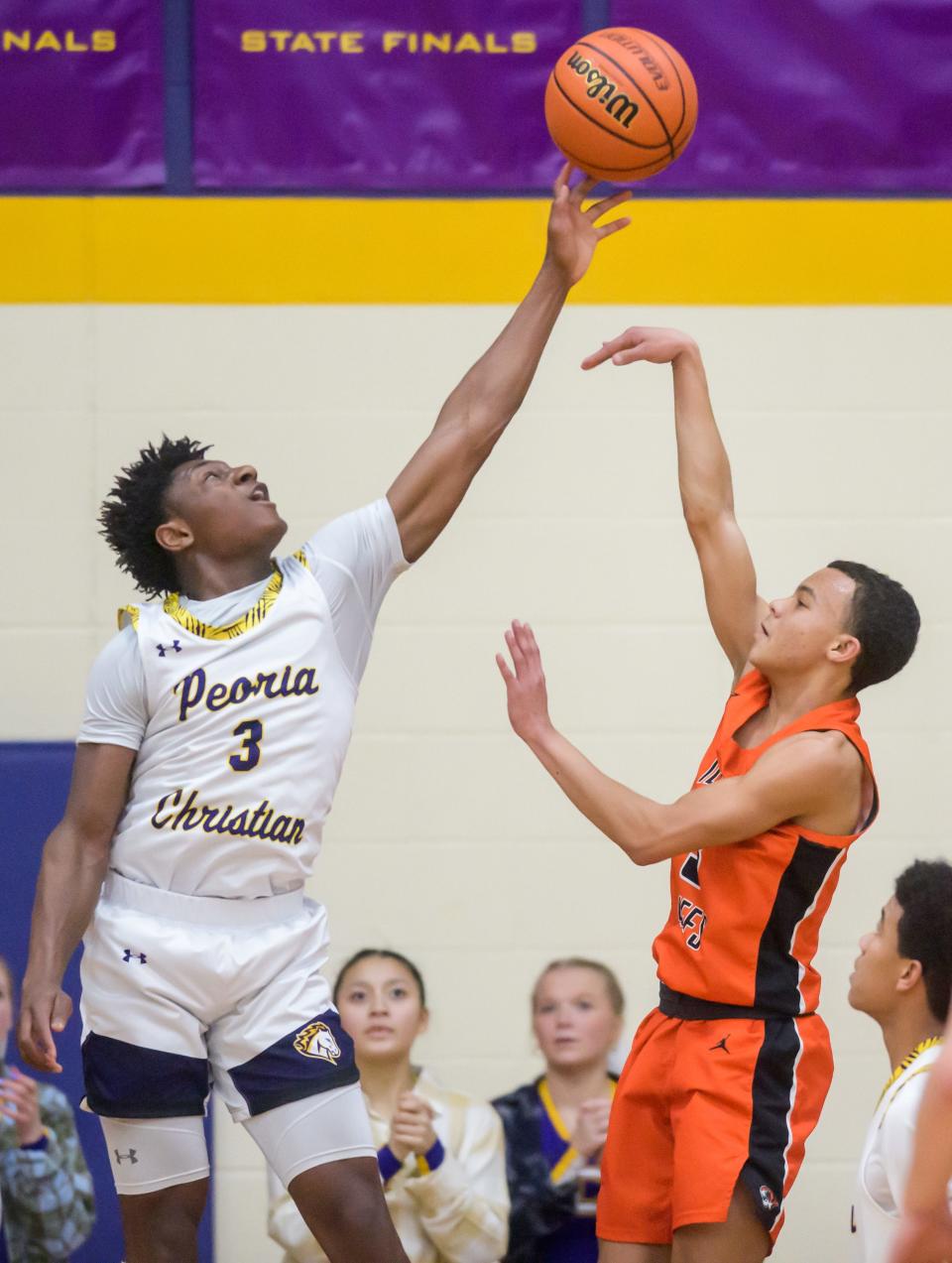 Peoria Christian's Keton Isuwami (3) blocks a shot from Illini Bluffs' Jayden Washington in the second half Friday, Jan. 20, 2023 at Peoria Christian High School. The Tigers defeated the Crusaders 45-35.