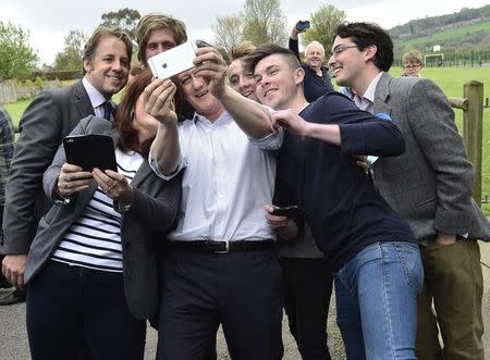 Britain's Prime Minister Cameron joins local supporters in a 'selfie' photograph whilst campaigning in Norton Sub Hamdon near Yeovil, south west England, Britain