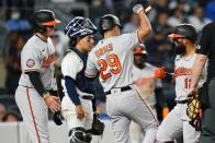 Baltimore Orioles' Adley Rutschman, left, and Ramon Urias, center, celebrate with Rougned Odor, right, after they scored on Odor's three-run home run during the seventh inning of the team's baseball game against the New York Yankees on Tuesday, May 24, 2022, in New York. (AP Photo/Frank Franklin II)