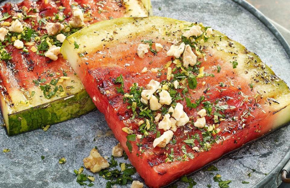 <p>This grilled watermelon recipe embraces the feeling of summer. These watermelon steaks are marinated in balsamic vinegar, lemon juice and rosemary before being placed on the grill and then topped with a crunchy walnut gremolata.</p> <p><a href="https://www.thedailymeal.com/best-recipes/grilled-watermelon-steaks?referrer=yahoo&category=beauty_food&include_utm=1&utm_medium=referral&utm_source=yahoo&utm_campaign=feed" rel="nofollow noopener" target="_blank" data-ylk="slk:For the Grilled Watermelon Steaks with Walnut Gremolata recipe, click here.;elm:context_link;itc:0;sec:content-canvas" class="link ">For the Grilled Watermelon Steaks with Walnut Gremolata recipe, click here.</a></p>