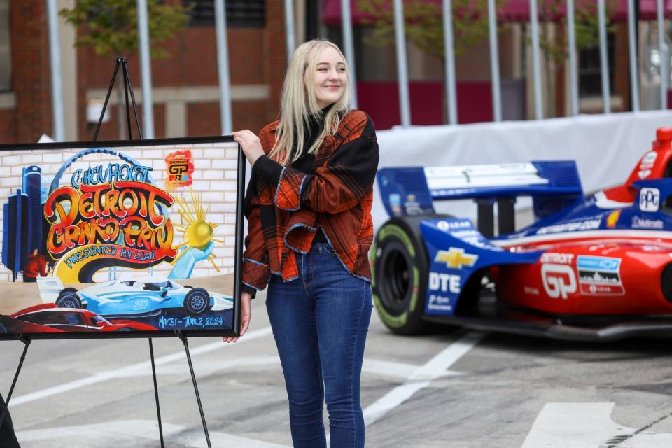 Alison Slackta, College for Creative Studies senior, unveils her winning 2024 Chevrolet Detroit Grand Prix presented by Lear official poster, during a press conference near the race's finish line in downtown Detroit on Wed., May 1, 2024.