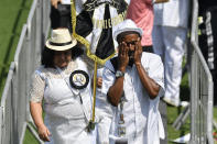 A fan of Pele wipes tears in a line of people waiting to pay their last respects to the late Brazilian soccer great, lying in state at Vila Belmiro stadium, in Santos, Brazil, Monday, Jan. 2, 2023. (AP Photo/Matias Delacroix)