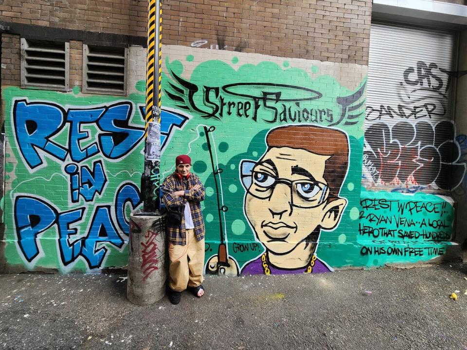 'Ryan went the extra mile for the DTES, we should go the extra mile for him,' said graffiti artist Smokey D, who painted a mural in memory of Vena in 'Piss Alley,' the 'worst' alley for overdoses recorded between 1 a.m. and 6 a.m., according to Trey Helten, manager of the Overdose Prevention Society. Smokey D, whose real name is James Hardy, is pictured in front of the mural on June 17, 2023.