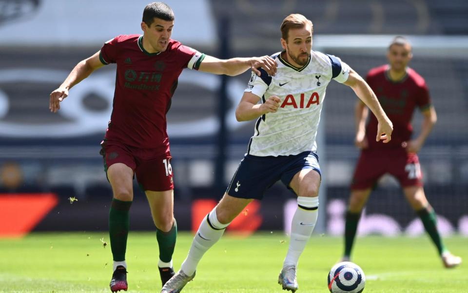 Harry Kane (right) looks to accelerate away from Conor Coady - AP