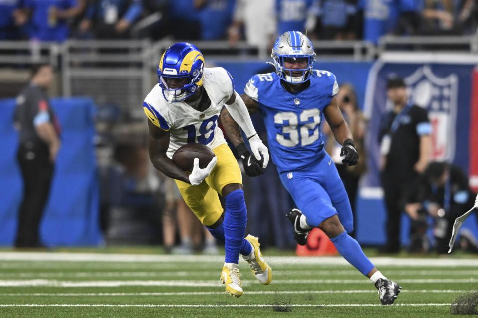 Rams receiver Tyler Johnson (18) runs to complete a 63-yard reception as Lions safety Brian Branch (32) pursues.