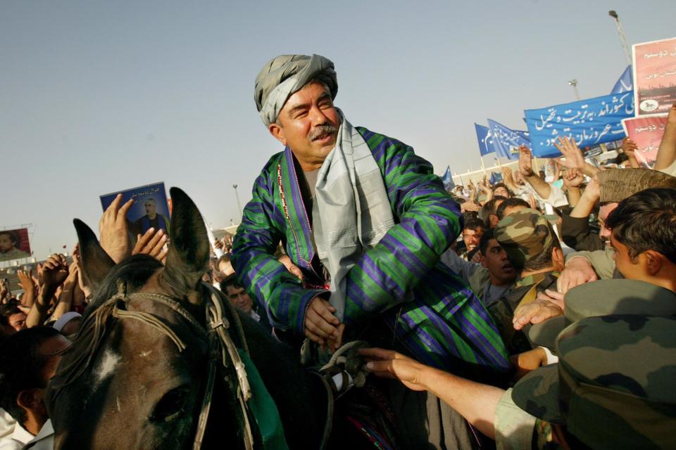 KABUL,AFGHANISTAN - OCTOBER 6: Presidential candidate General Abdul Rashid Dostum sits on a horse during his final campaign rally October 6,2004 at Kabul stadium in Kabul, Afghanistan. Afghans will participate for the first time in direct presidential elections on October 9. (Photo by Paula Bronstein/Getty Images)
