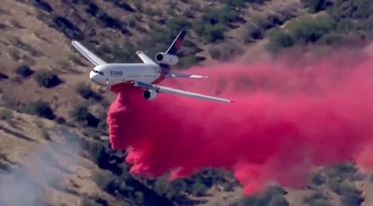 A plane works to combat the Copper Canyon Fire in Arizona.