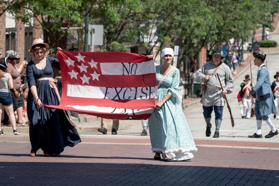 Reenactors carry a rebellion flag in the street during a previous festival.