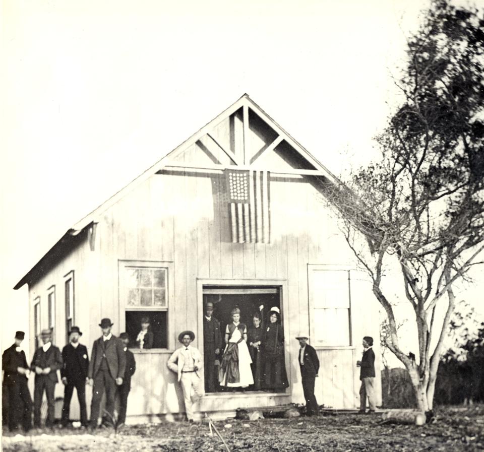 The schoolhouse in 1886 in Palm Beach. The first schoolteacher was 16-year-old Hattie Gale, who can be seen in the doorway.