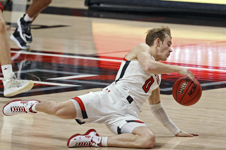 Texas Tech's Mac McClung (0) falls down while dribbling down the court during the first half of an NCAA college basketball game against Incarnate Word, Tuesday, Dec. 29, 2020, in Lubbock, Texas. (AP Photo/Brad Tollefson)