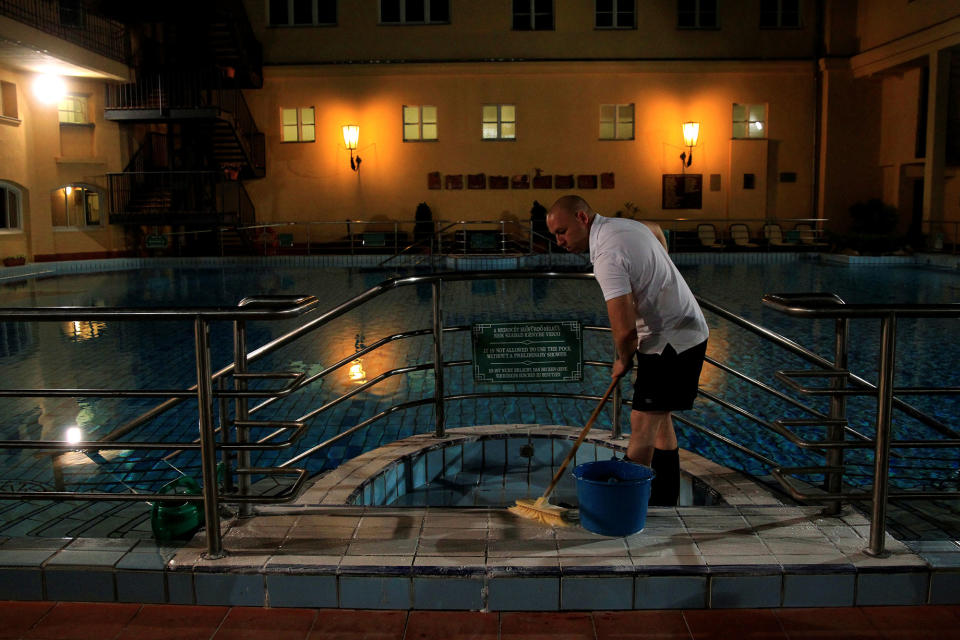 <p>A worker cleans a pool at the Lukacs Bath in Budapest, Hungary on July 6, 2016. (REUTERS/Bernadett Szabo) </p>