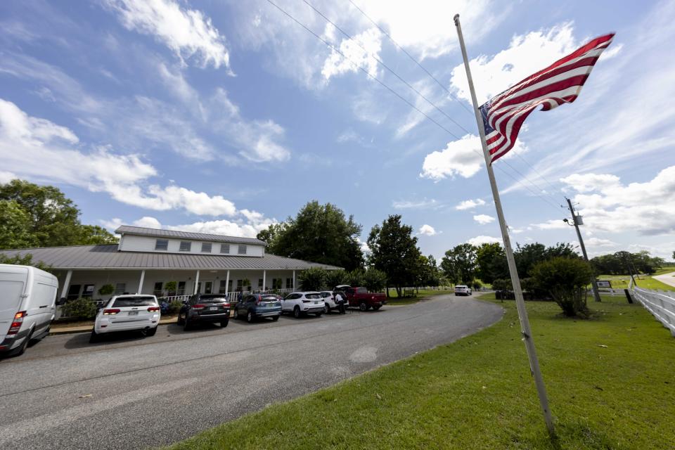 The Us Flag flies at half mast Sunday, June 20, 2021, in Camp Hill, Ala., at the Alabama Sheriff's Girls Ranch which suffered a loss of life when their van was involved in a multiple vehicle accident Saturday, resulting in eight people in the van perishing. (AP Photo/Vasha Hunt)