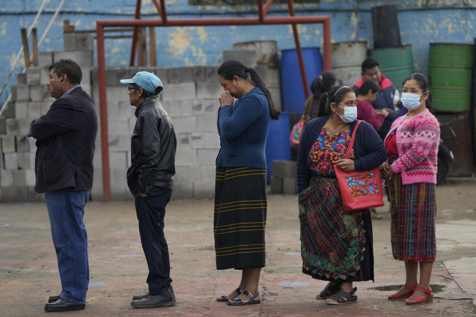 Voters line up at a poling station during general elections in Sumpango, Guatemala, Sunday, March 25, 2023. (AP Photo/Moises Castillo)