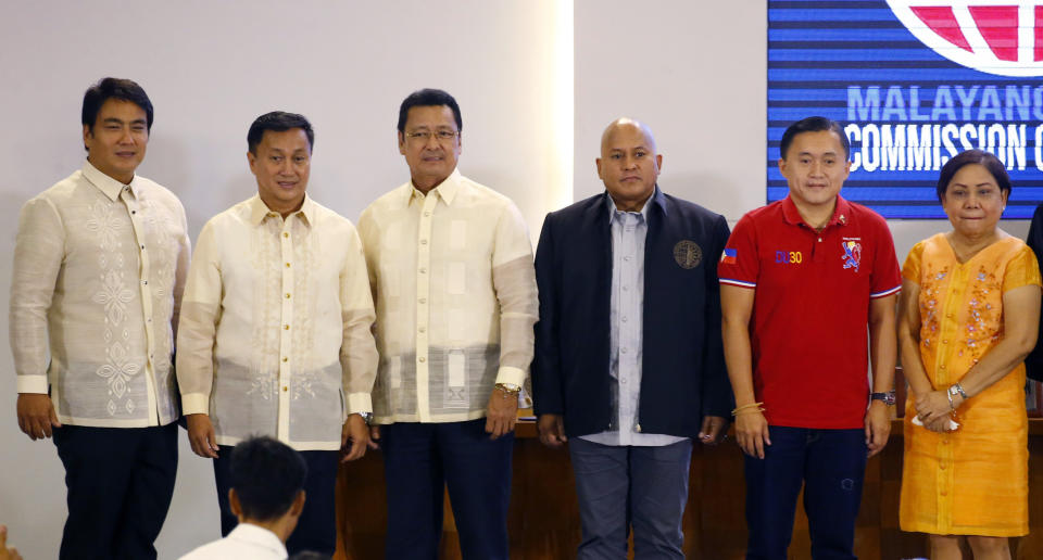 Six of the twelve new senators pose following proclamation ceremony at the Commission on Elections in suburban Pasay city, south of Manila, Philippines Wednesday, May 22, 2019. They are, from left, Senators Bong Revilla, Francis Tolentino, Lito Lapid, Ronald Dela Rosa, Christopher Go, and Cynthia Villar. (AP Photo/Bullit Marquez)