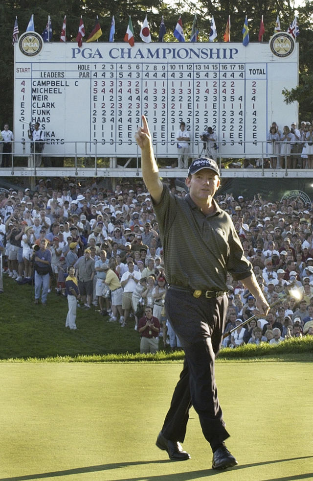 FILE - Shaun Micheel holds up a number one finger on the 18th green after winning the 85th PGA Championship golf tournament at Oak Hill Country Club in Rochester, N.Y. Sunday, Aug. 17, 2003. The PGA Championship returns to Oak Hill on May 18-21, 2023 in cooler temperatures of May. (AP Photo/Steven Senne, File)
