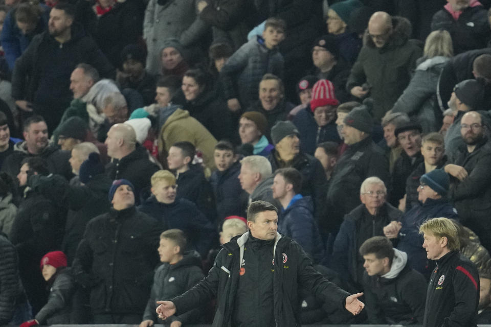 Sheffield's manager Paul Heckingbottom, centre, reacts during the FA Cup 4th round soccer match between Sheffield United and Wrexham at the Bramall Lane stadium in Sheffield, England, Tuesday, Feb. 7, 2023. (AP Photo/Jon Super)