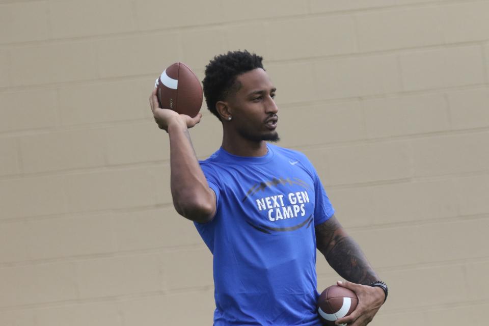 Former Madison Ram and current Kentucky Wildcat Tyrell Ajian throws a ball during a drill at the Nike Skills Football Camp at Arlin Field this week.