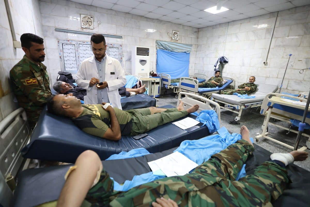 Iraqi military personnel receive treatment at a hospital in Hilla  on Saturday (AFP via Getty Images)