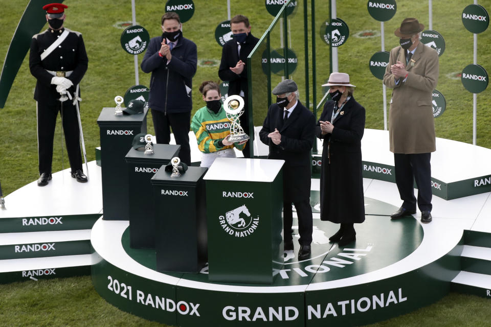 Rachael Blackmore, center, ridding Minella Times celebrates after winning the Randox Grand National Handicap Chase on the third day of the Grand National Horse Racing meeting at Aintree racecourse, near Liverpool, England, Saturday April 10, 2021. (AP Photo/Scott Heppell, Pool)