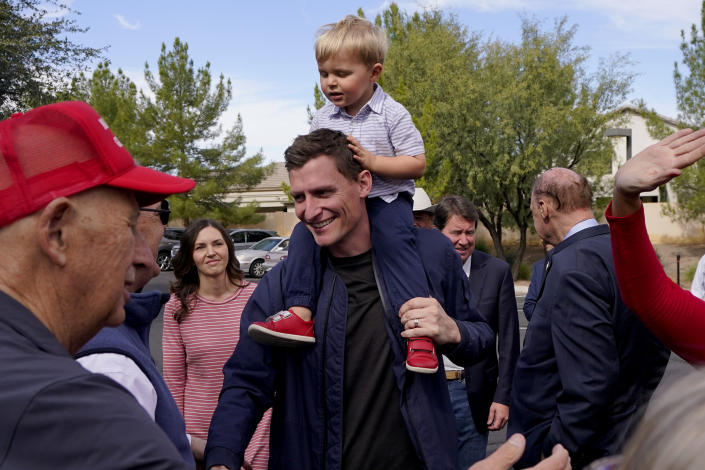 Republican U.S. Senate candidate Blake Masters holds his son, Rex, 2, as he speaks with supporters, Monday, Nov. 7, 2022, in Gilbert, Ariz. (AP Photo/Matt York)