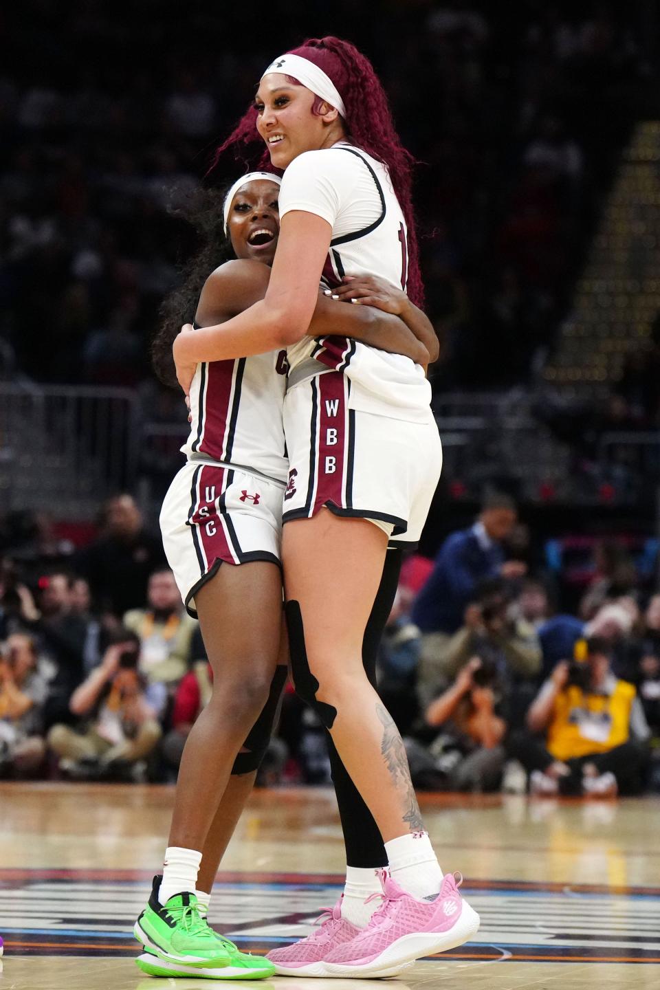 South Carolina's Raven Johnson (25) and Kamilla Cardoso (10) react in the third quarter of Friday's national semifinal game against North Carolina State at Rocket Mortgage FieldHouse.