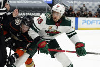 Anaheim Ducks center Adam Henrique (14) faces off against Minnesota Wild center Victor Rask (49) during the first period of an NHL hockey game Monday, Jan. 18, 2021, in Anaheim, Calif. (AP Photo/Marcio Jose Sanchez)