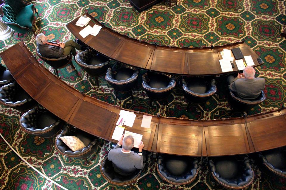 Vermont senators sit spaced apart to meet the social distance requirements set by the governor, Tuesday March 24, 2020, at the Statehouse in Montpelier, Vt. The Senate met with 17 members, one over the required quorum, to pass legislation needed to confront the coronavirus pandemic.