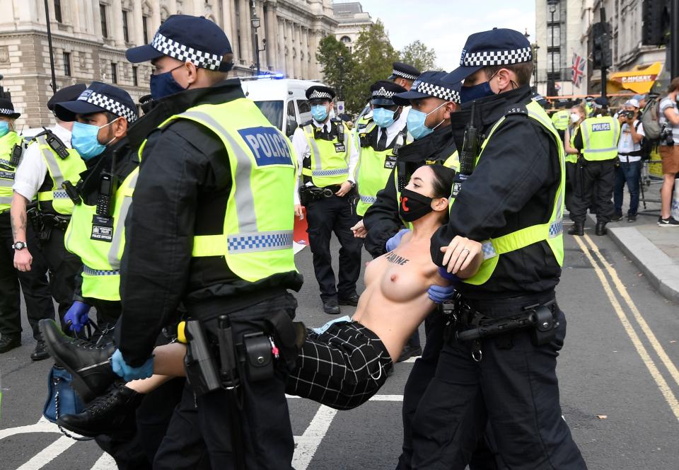 SENSITIVE MATERIAL. THIS IMAGE MAY OFFEND OR DISTURB Police officers remove an Extinction Rebellion climate activist after they had attached themselves to the Houses of Parliament, during a protest in London, Britain, September 10, 2020. REUTERS/Toby Melville