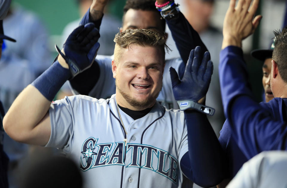 Seattle Mariners designated hitter Daniel Vogelbach is congratulated by teammates after his solo home run during the second inning of a baseball game against the Kansas City Royals at Kauffman Stadium in Kansas City, Mo., Monday, April 8, 2019. (AP Photo/Orlin Wagner)