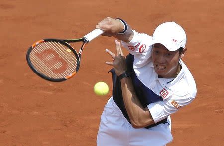 Kei Nishikori of Japan plays a shot to Thomaz Bellucci of Brazil during their men's singles match at the French Open tennis tournament at the Roland Garros stadium in Paris, France, May 27, 2015. REUTERS/Gonzalo Fuentes