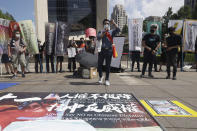 People gather to protest against China on human rights on the eve of China's National Day in front of the Bank of China in Taipei, Taiwan Friday, Sept. 30, 2022. (AP Photo/Chiang Ying-ying)