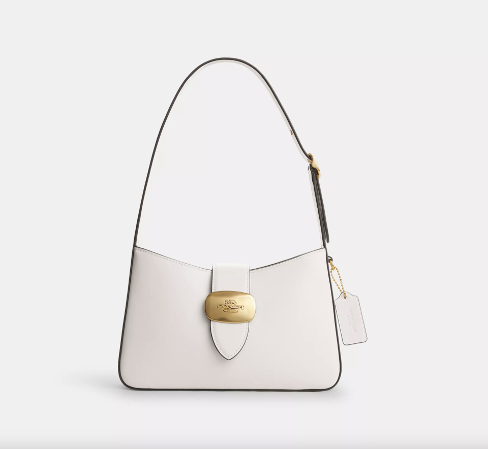 Eliza Shoulder Bag in white with gold hardware (Photo via Coach Outlet)