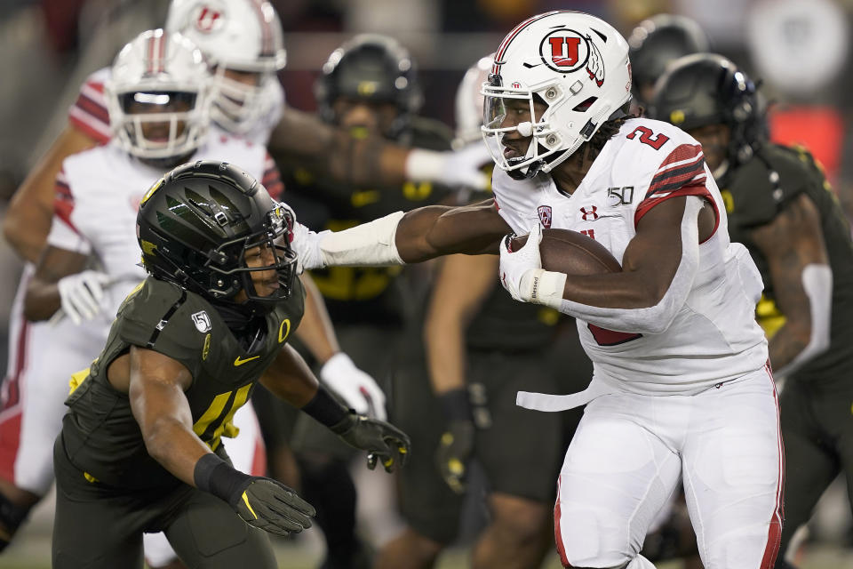 Utah running back Zack Moss (2) stiff-arms Oregon cornerback Thomas Graham Jr. (4) during the first half of the Pac-12 Conference championship NCAA college football game in Santa Clara, Calif., Friday, Dec. 6, 2018. (AP Photo/Tony Avelar)