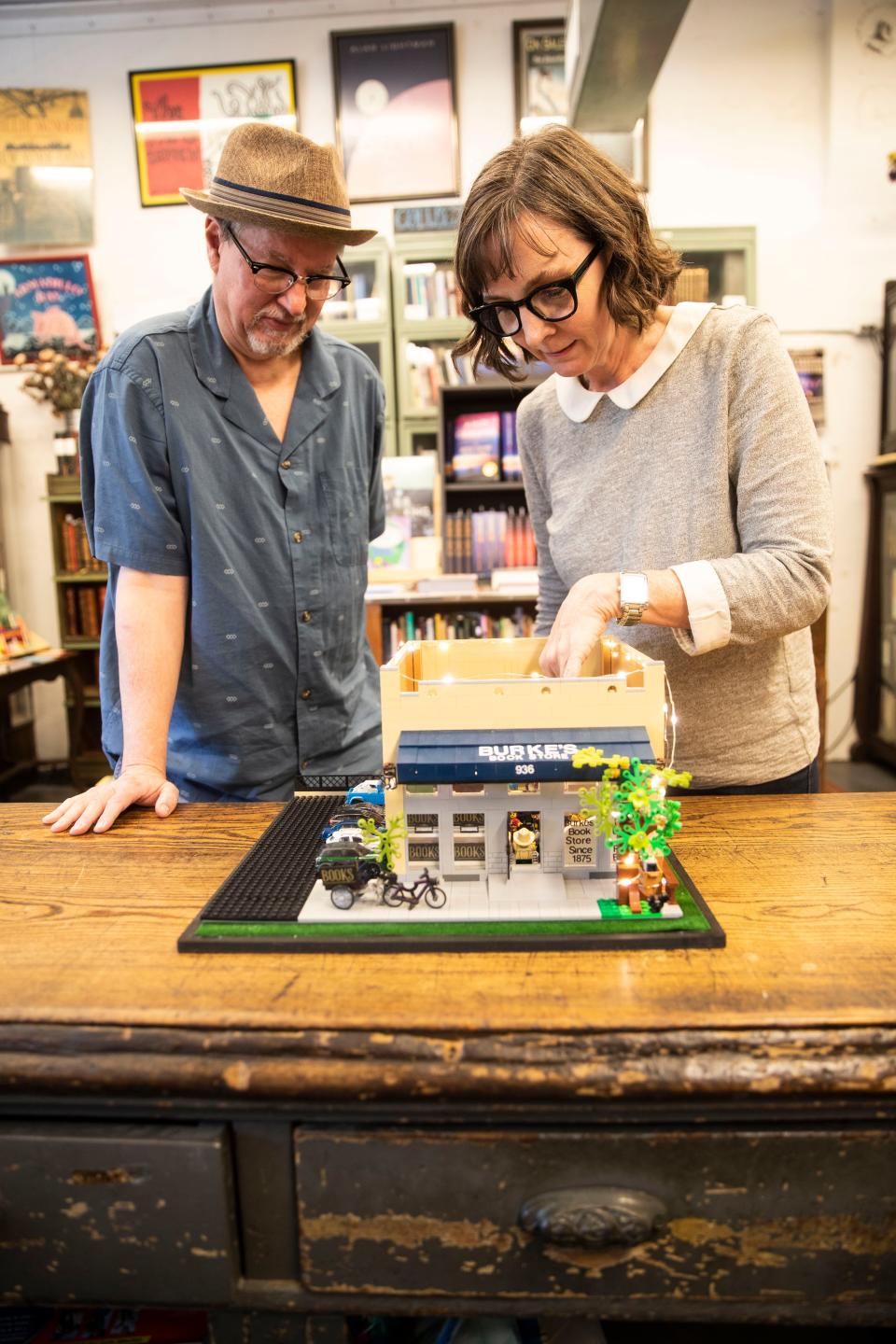 Cheryl Mesler, co-owner of Burke's Book Store, builds a Lego replica model of the store on Nov. 9, 2022, in Memphis.