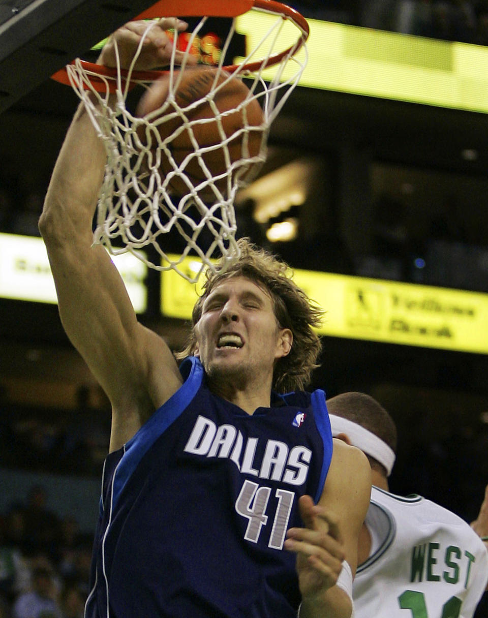 FILE - Dallas Mavericks' Dirk Nowitzki (41), of Germany, dunks against Boston Celtics' Delonte West during the fourth quarter of an NBA basketball game in Boston, Jan. 9, 2006. Nowitzki was announced Friday, Feb. 17, 2023, as being among the finalists for enshrinement later this year by the Basketball Hall of Fame. The class will be revealed on April 1. (AP Photo/Elise Amendola, File)