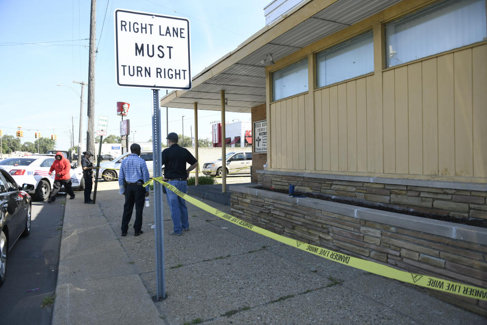 Detroit Police and investigators look over a homicide scene on Wyoming Avenue, near the corner of Seven Mile Road, Sunday, Aug. 28, 2022, in Detroit. Four people were shot, with fatalities, by a person who appeared to be firing at people randomly over a roughly 2 1/2-hour period Sunday morning in Detroit, police said. (Jose Juarez/Special to Detroit News via AP)