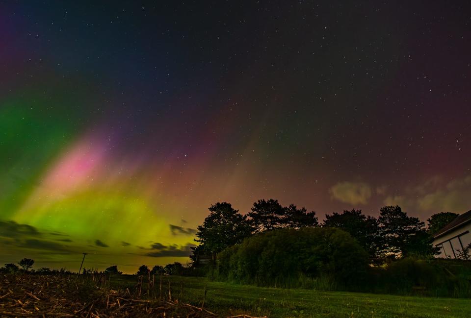 The northern lights, or aurora borealis, on Friday, May 10, 2024, in Alaiedon Township, near Lansing, Mich.