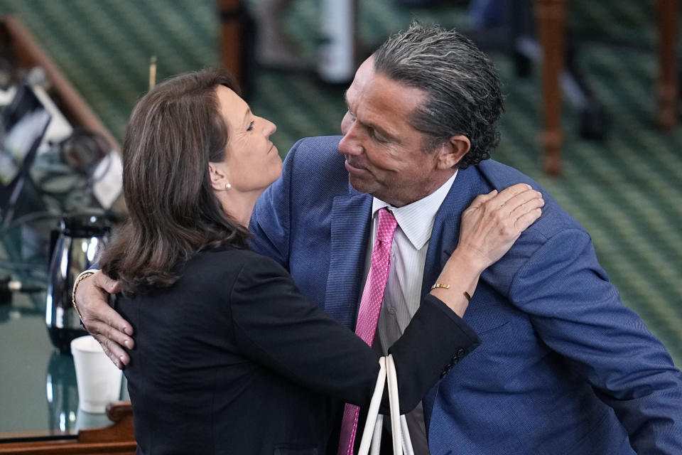 State Sen. Angela Paxton, R-McKinney, wife of suspended Texas state Attorney General Ken Paxton, left, embraces defense attorney Tony Buzbee, right, as they celebrate the acquittal of her husband in his impeachment trial in the Senate Chamber at the Texas Capitol, Saturday, Sept. 16, 2023, in Austin, Texas. (AP Photo/Eric Gay)