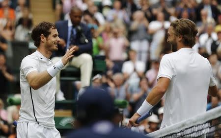 Britain Tennis - Wimbledon - All England Lawn Tennis & Croquet Club, Wimbledon, England - 28/6/16 Great Britain's Andy Murray celebrates as he shakes hands with Great Britain's Liam Broady after winning their match REUTERS/Stefan Wermuth