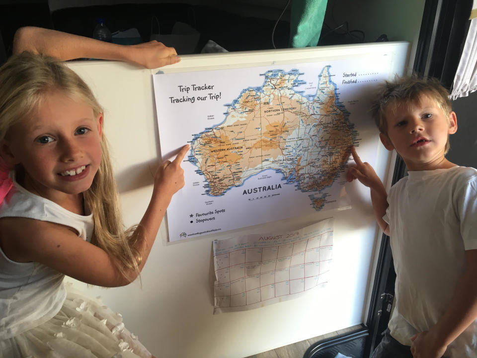 The Pullock children pointing at a map of Australia that charted their 10-month journey.