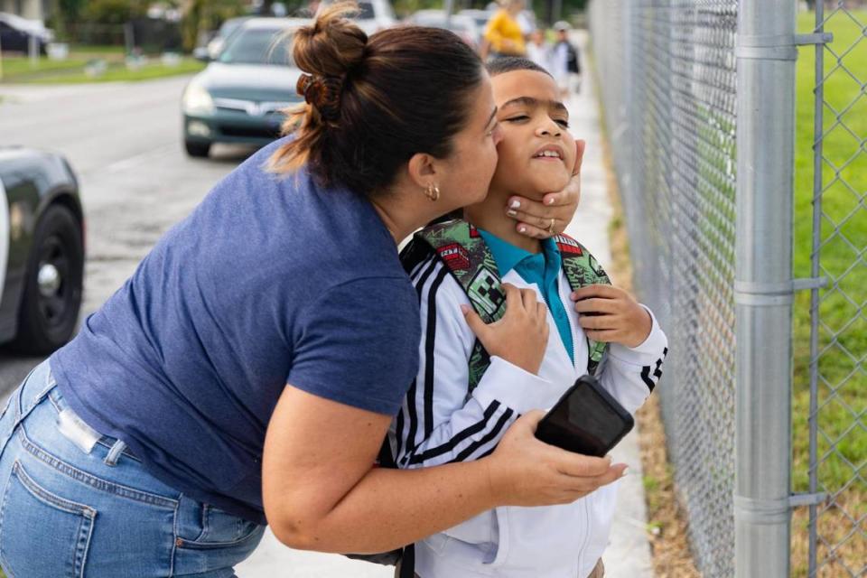 Yaremys Orta kisses her son Maykol Gonzalez, 9, before he goes into Miami Gardens Elementary School for his first day of third grade on Thursday, Aug. 17, 2023 in Miami Gardens, Fla.