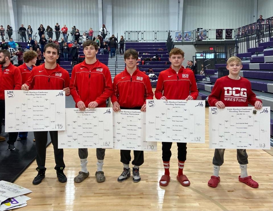 DCG wrestlers, from left, Lane Nelsen, Ben Brushaber, Jacob Fistler, Logan Gard and Ayden Beck pose for a photo after placing first during the Little Hawkeye Conference tournament on Saturday, Jan. 28, 2023.