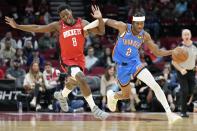 Oklahoma City Thunder guard Shai Gilgeous-Alexander (2) is fouled by Houston Rockets forward Jae'Sean Tate during the first half of an NBA basketball game, Wednesday, Feb. 1, 2023, in Houston. (AP Photo/Eric Christian Smith)