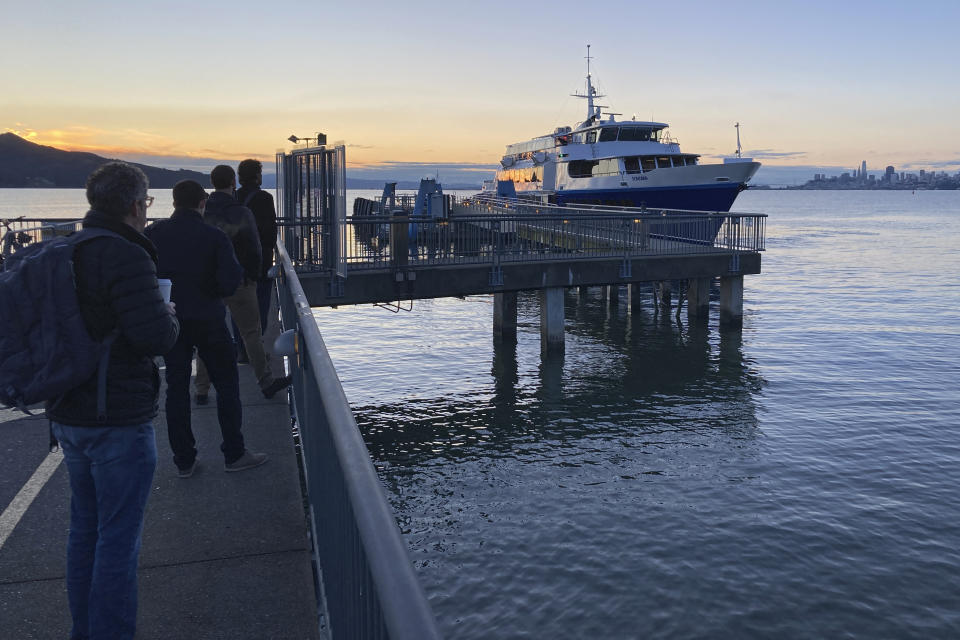 Commuters line up in Sausalito, Calif., to ride the Golden Gate Transit ferry to San Francisco on March 30, 2023. California's public transit agencies say they are running out of money, plagued by depleted ridership from the pandemic and soon-to-expire federal aid. But California's state government is having its own financial problems, leaving the fate of public transit agencies uncertain in this car-obsessed state. (AP Photo/Eric Risberg)