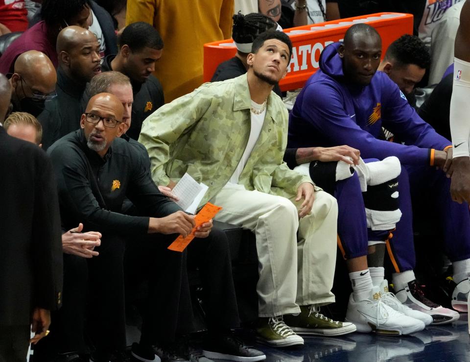 Apr 24, 2022; New Orleans, Louisiana, U.S.;  Phoenix Suns guard Devin Booker watches his team play against the New Orleans Pelicans during Game 4 of the Western Conference playoffs.