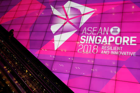 A woman passes the ASEAN Summit signage at Suntec Convention Centre in Singapore, November 11, 2018. REUTERS/Edgar Su