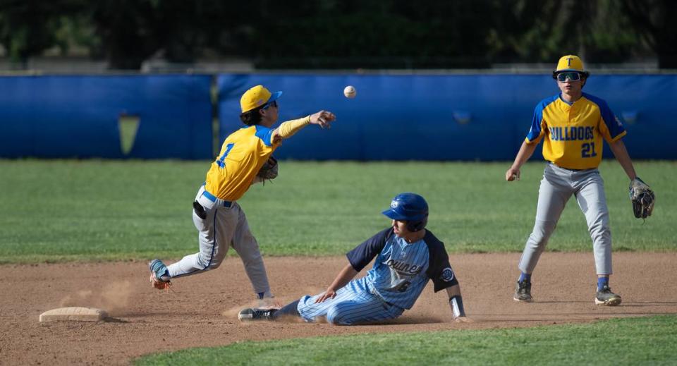 Turlock’s Joshua Ramirez turns a double play during the Central California Athletic League game with Downey at Downey High School in Modesto, Calif., Friday, April 12, 2024. Turlock won the game 3-2.
