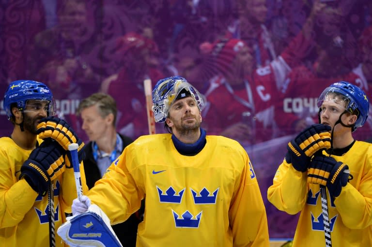 Sweden's silver medallist Henrik Lundqvist (centre) reacts during the Men's Ice Hockey Medal Ceremony at the Bolshoy Ice Dome during the Sochi Winter Olympics on February 23, 2014