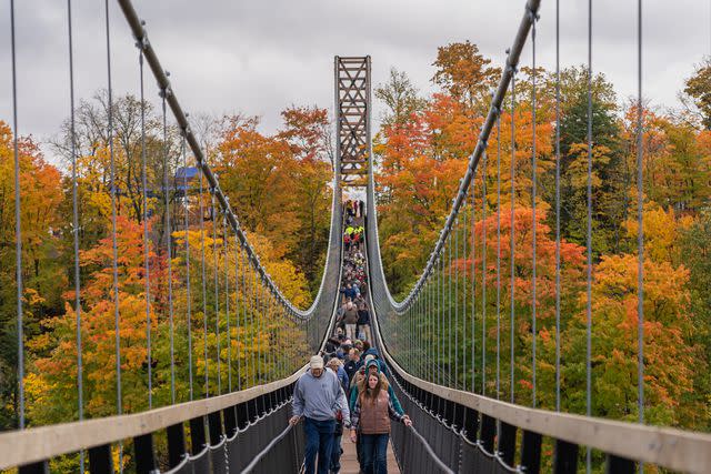 <p>Courtesy of SkyBridge Michigan</p> Crowds of people walking over the Skybridge in Michigan during the fall time